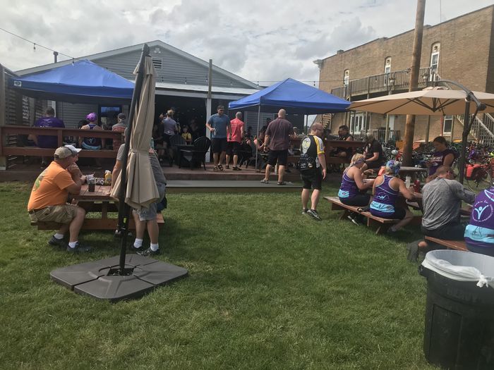 The back lawn on a ride day, blue tents up and riders at the picnic tables
