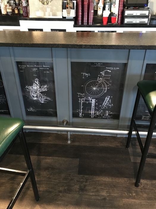 Vintage bicycle patent drawings set into the front of the bar