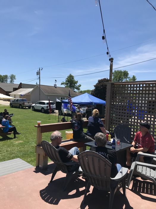 Adirondack chairs on the sunny patio, string lights overhead