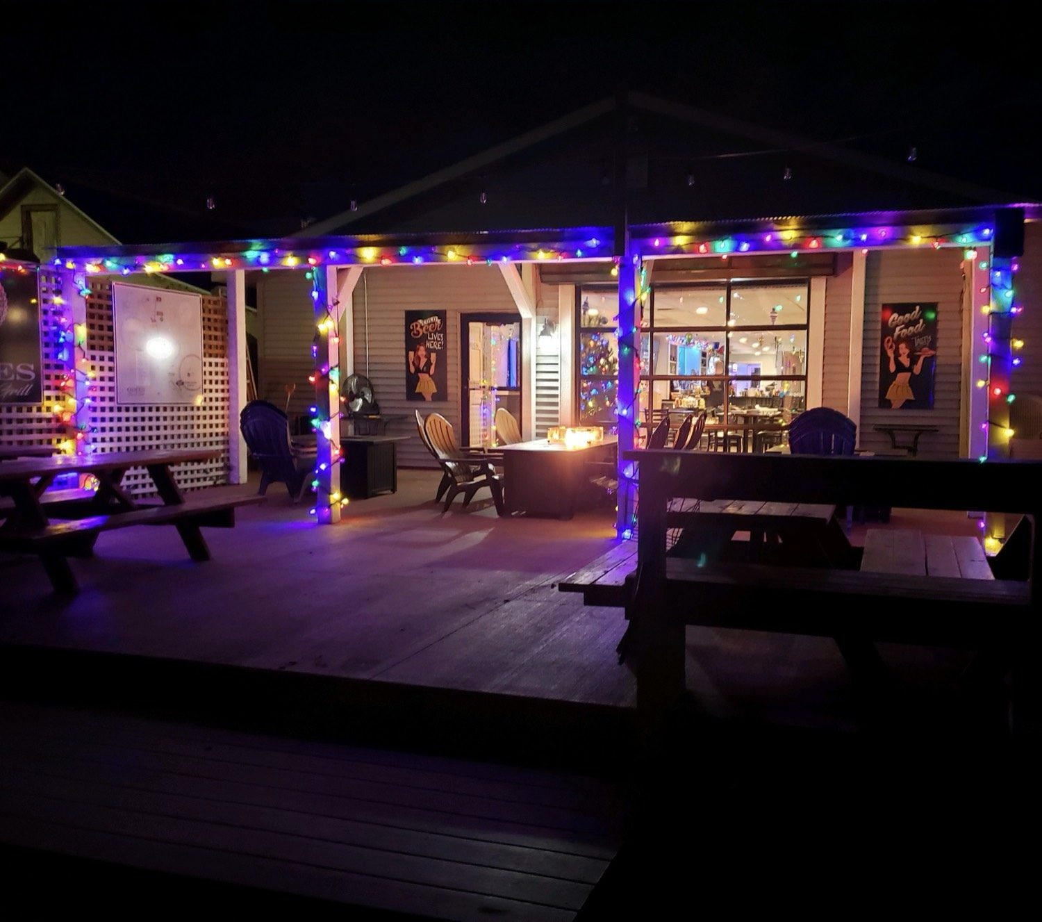 The patio at night, strung with lights