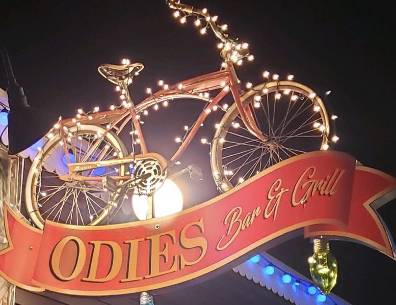 The Odie's Bar and Grill sign, a bicycle wrapped in lights